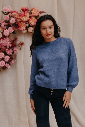 Femme avec un pull bleu.